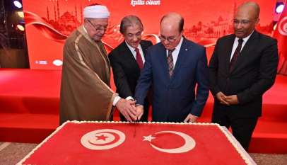 قطع كعكة تحمل علمي تونس وتركيا خلال احتفال سفارة تركيا بتونس بالذكرى الـ103 لتأسيس الجمهورية